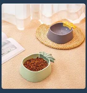 Detailed view of cute pineapple-shaped pet bowls for cats and dogs in a cozy home setting