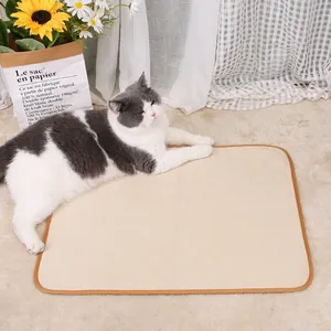 Cat resting comfortably on a beige quilted washable pet pee mat in a cozy home setting