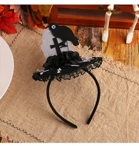 Detailed view of Halloween headband featuring tombstone, black crow, and lace-trimmed mini hat.