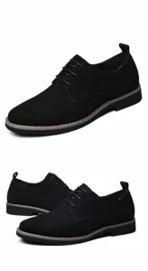 Macro view of black matte suede leather men's stylish casual lace-up dress shoes