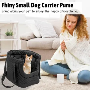 Black quilted pet carrier bag with a cat inside, shown in a cozy, bright living room.