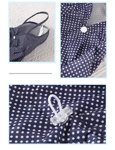 Detail view of blue polka dot dog raincoat with snap button and drawstring toggle