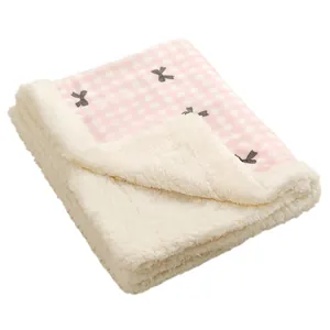 Soft pink plaid pet blanket with bow pattern and cream fleece lining for cats and dogs.