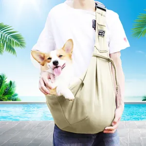 Comfortable beige pet sling carrier for small dogs shown in an outdoor poolside setting.