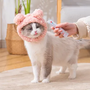 Cute pink plush bear ear headgear for cats and small dogs in a warm indoor setting