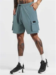 Close-up detail of men's dusty blue quick-dry cargo sports shorts with multiple pockets