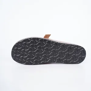Close-up detail of the durable black anti-slip rubber outsole on a brown suede mule