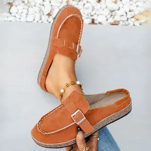 Detail view of orange faux suede mule sandals with metal buckle and platform sole