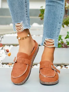Casual brown suede platform clogs featuring metal buckle and decorative white stitching