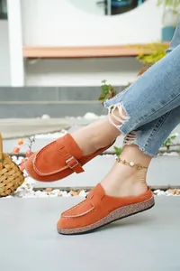Stylish orange faux suede closed-toe mules featuring a metal buckle and cork sole
