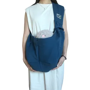 Comfortable blue pet sling carrier bag for small cats and dogs shown on a model