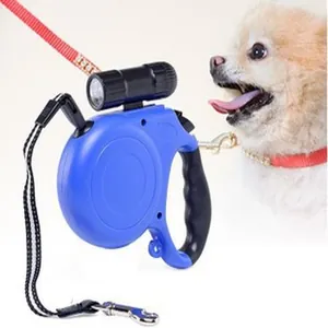 Retractable blue dog leash with flashlight and comfortable grip for night walks.
