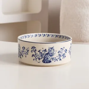 Vintage blue and white ceramic cat bowl featuring floral and kitten illustrations