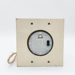 Detailed bottom view of wooden Christmas ornament showing battery compartment and switch