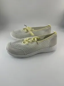 Detailed side view of breathable white mesh slip-on shoes with yellow laces