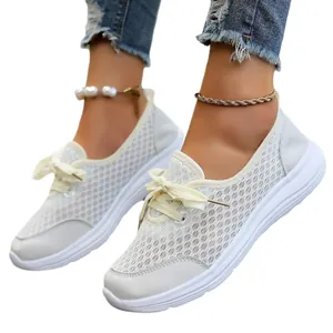 White breathable mesh slip-on sneakers for women, comfortable casual flat walking shoes.