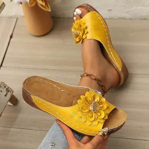 Detailansicht gelber Keilsandalen mit 3D-Blumendekor und atmungsaktivem, hohlem Obermaterial