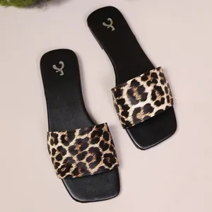 Comfortable leopard print flat slide sandals for women with a modern minimalist design.