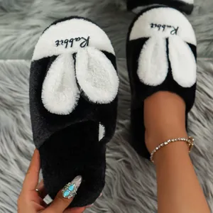 Close-up detail of fluffy black and white rabbit plush slippers for home use