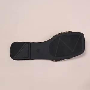 Detail of anti-slip black sole and size 36 on leopard print flat slide sandals