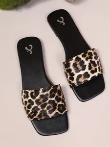 Detailed top view of women's flat slides with classic leopard print pattern strap
