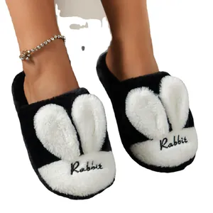 Cozy black and white plush rabbit ear slippers for warm indoor winter home wear