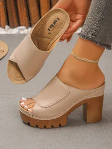 Close-up of retro peep-toe platform mule sandals with textured wood block heels