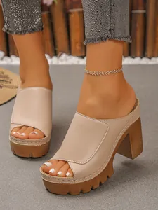 Close-up of beige platform mule sandals with chunky block heels and a stylish peep-toe