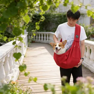 Red crossbody pet sling carrier for small dogs and cats, head-out breathable design.