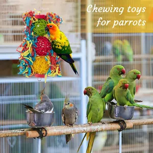 Detail showing a colorful bird chewing toy with rattan balls and shredded paper