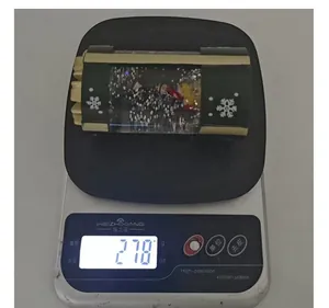 Christmas snow globe lantern decoration weighing 278g on a digital kitchen scale