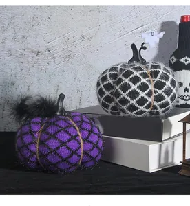 Detailed macro shot of handcrafted purple and checkered knitted Halloween pumpkins