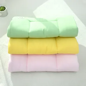Stack of soft macaron colored waffle texture pet cage mats for small cats and dogs