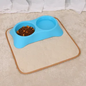 Detail of absorbent pet pee pad under a double feeding bowl on a soft beige rug.
