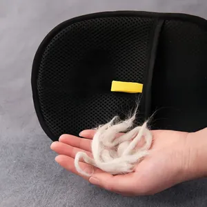 Pet static hair removal glove showing collected white cat fur in hand