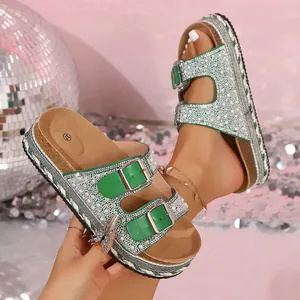 Detail of green platform sandals with rhinestone double buckles and pearl accents
