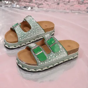 Macro view of green platform sandals decorated with pearls, rhinestones and cork soles