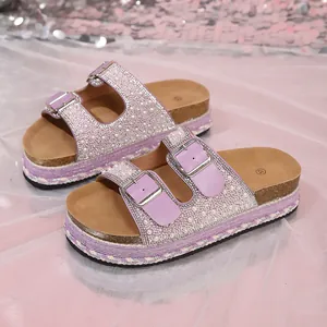 Close-up of purple platform sandals with pearl and rhinestone double strap design.