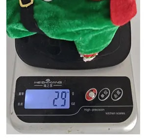 Detail showing the lightweight 29g Christmas elf wine bottle cover on a scale.
