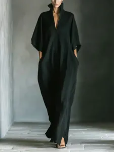 Elegant long black dress featuring a V-neck and loose silhouette with textured fabric