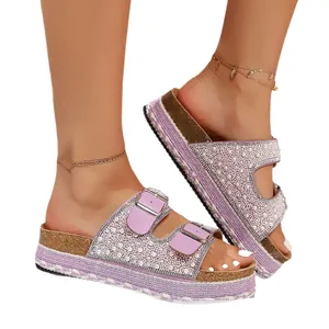 Purple platform sandals decorated with pearls, rhinestones, and double buckle straps.