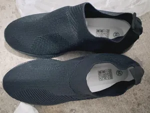 Overhead detail view of comfortable black fly-knit sock shoes with breathable mesh