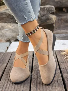 Scarpe comode in pelle scamosciata beige da donna con elastici incrociati e zeppa