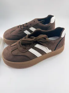 Retro brown suede GAT sneakers with white stripes and classic gum rubber soles.