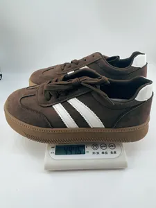 Detailed view of brown suede retro GAT sneakers on a scale showing a weight of 494.6 grams.
