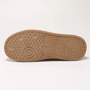 Macro view of the non-slip brown gum rubber outsole pattern of German Army Trainer shoes.