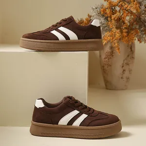 Vintage brown suede platform sneakers with white stripes and thick textured rubber soles