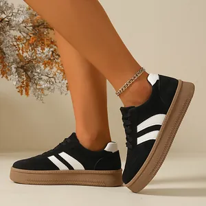 Close-up of retro black women's German Army Trainer sneakers with chunky gum soles