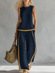 Detailed view of navy blue and yellow sleeveless top and wide-leg trousers two-piece set