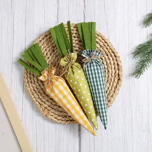 Set of three handmade Easter fabric carrots with gingham and polka dot patterns for decor